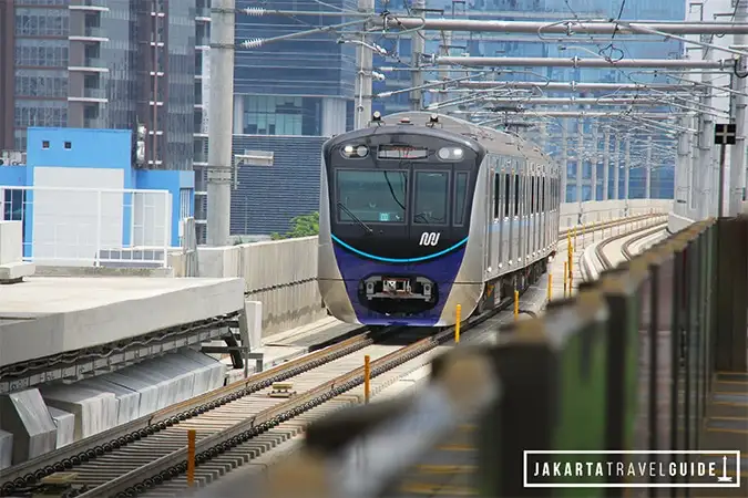 An MRT train arriving on the elevated section of the line
