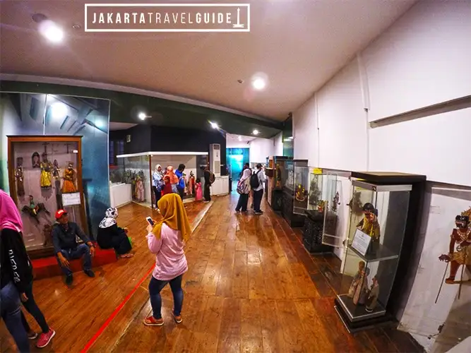 Visitors among the puppet displays in Museum Wayang