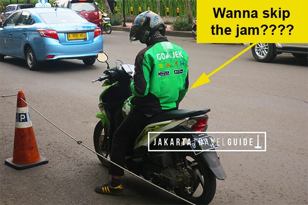 A GoJek driver in Jakarta waiting to pick up a passenger.